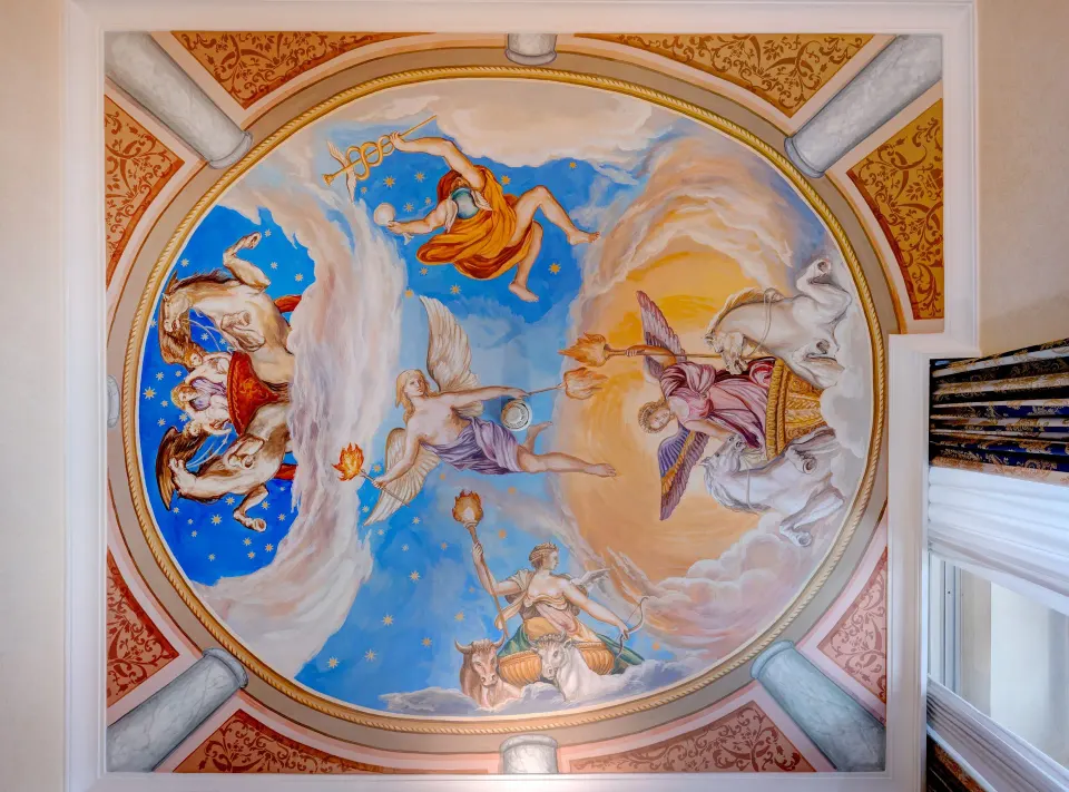 Hand-painted fresco on a Hotel Amalfi ceiling, with figures in a blue and gold oval frame